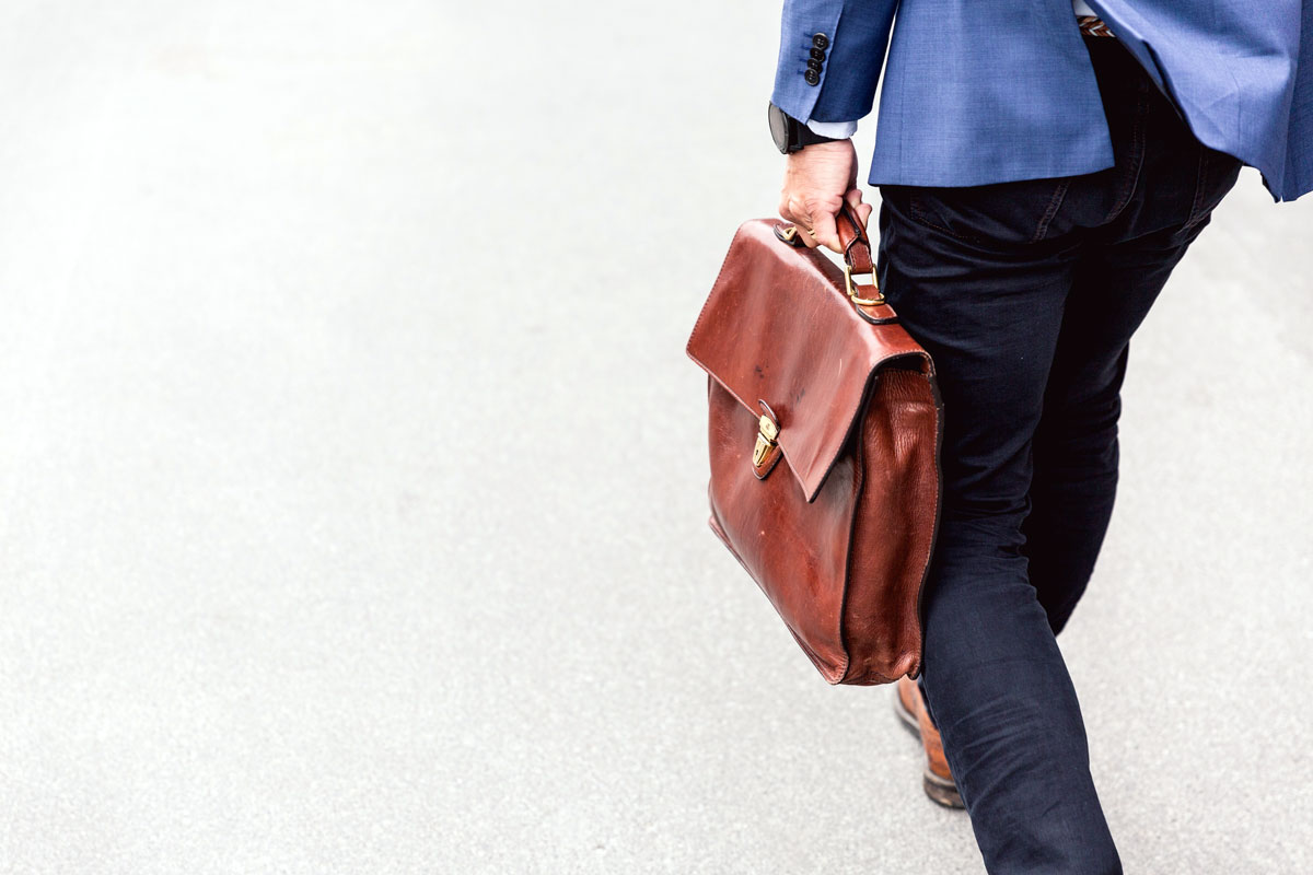 Man with briefcase walking towards destination